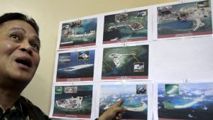 April 20, 2015: A top official with the Armed Forces of the Philippines shows some images of the structures being built by China in the South China Sea. (Reuters)